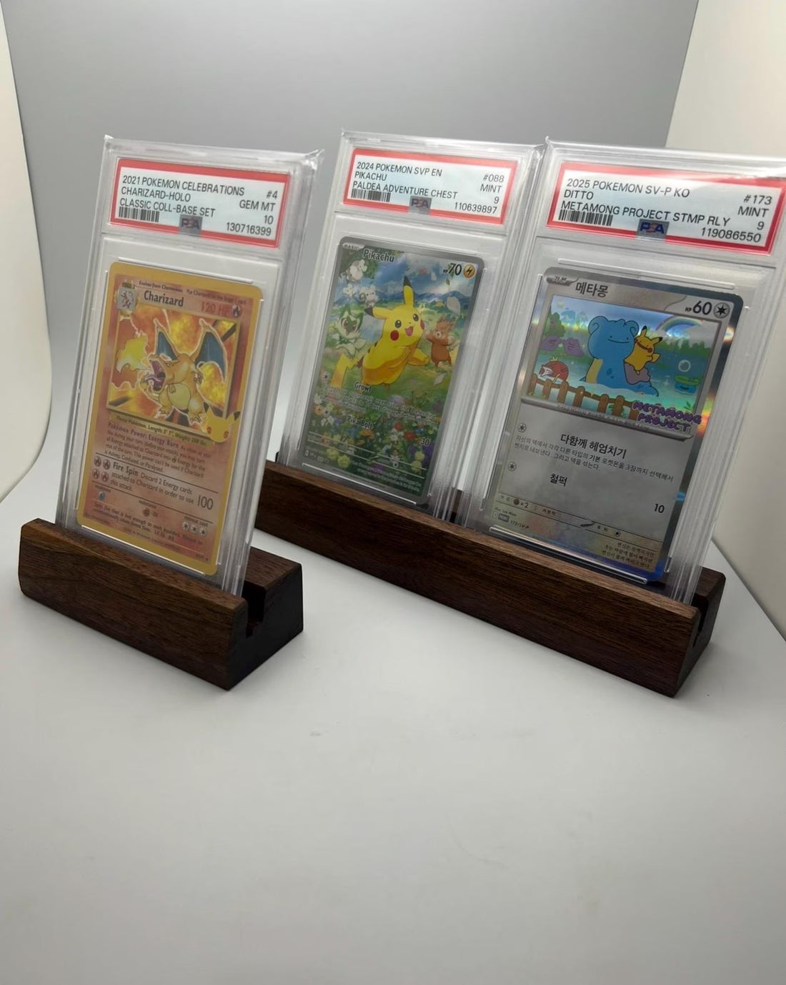 Hardwood graded card display stand holding graded trading card slabs