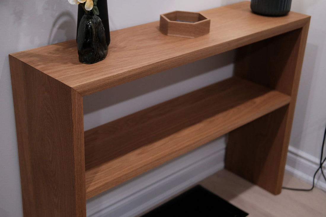 Handmade wooden console table with an open lower shelf and decorative objects on top