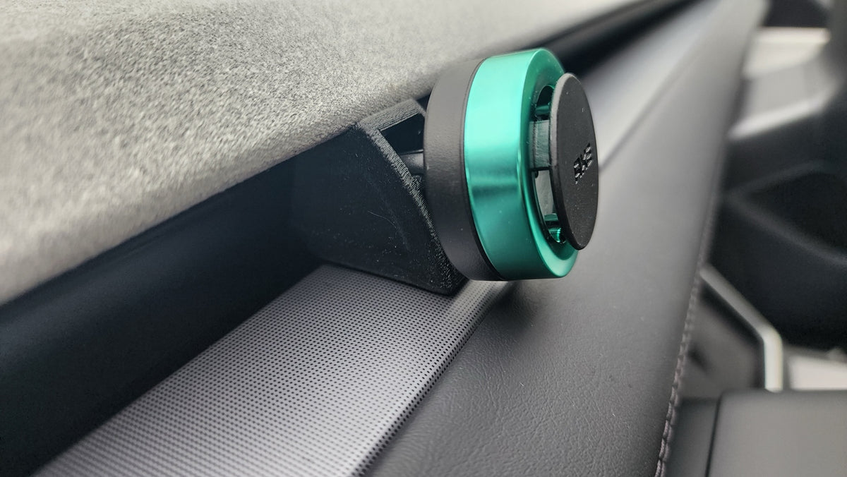 Tesla Juniper front vent air freshener holder installed in dashboard slot, side view