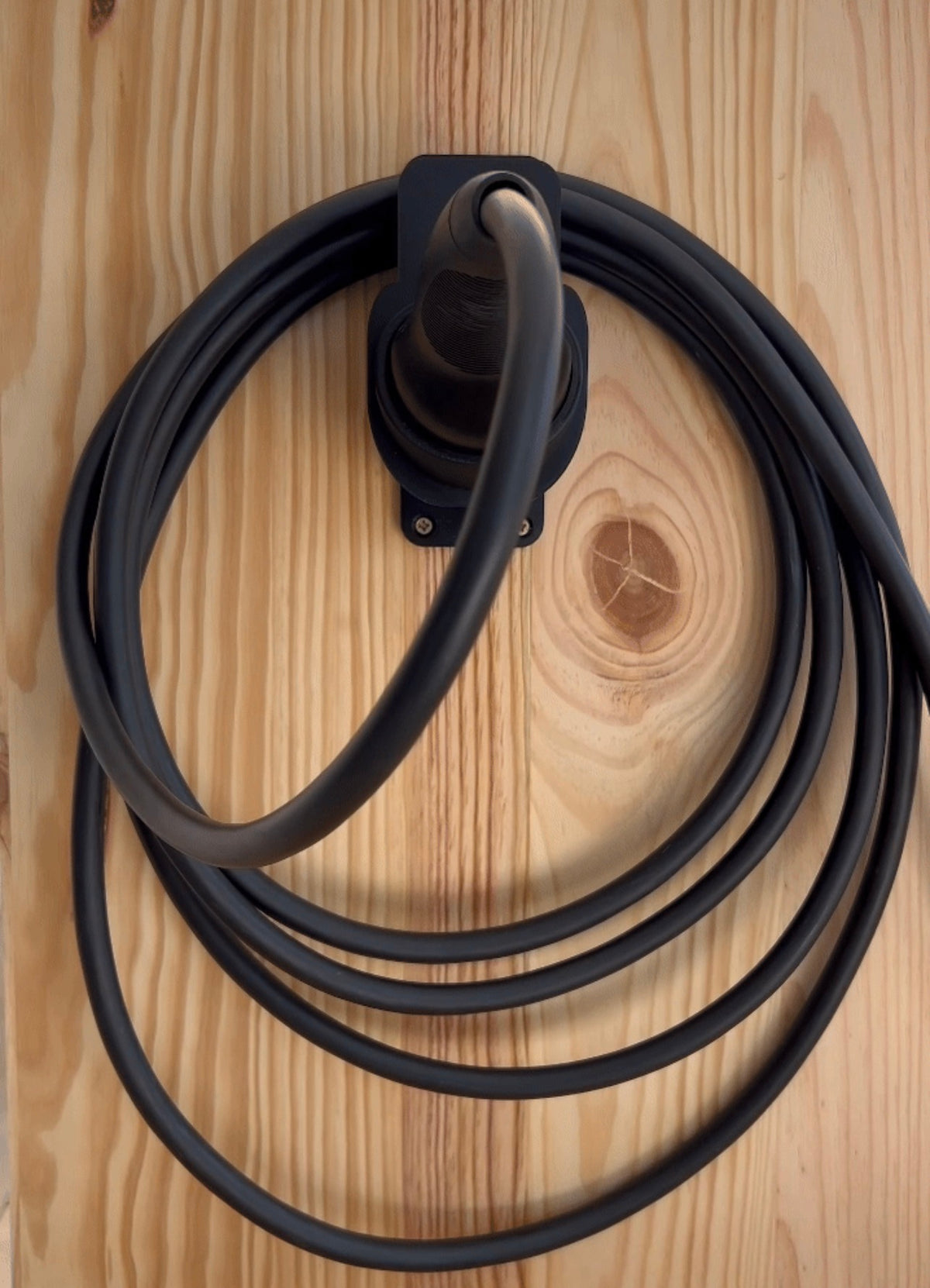 Charging cable coiled neatly on 3D printed Type 2 charging cable wall holder