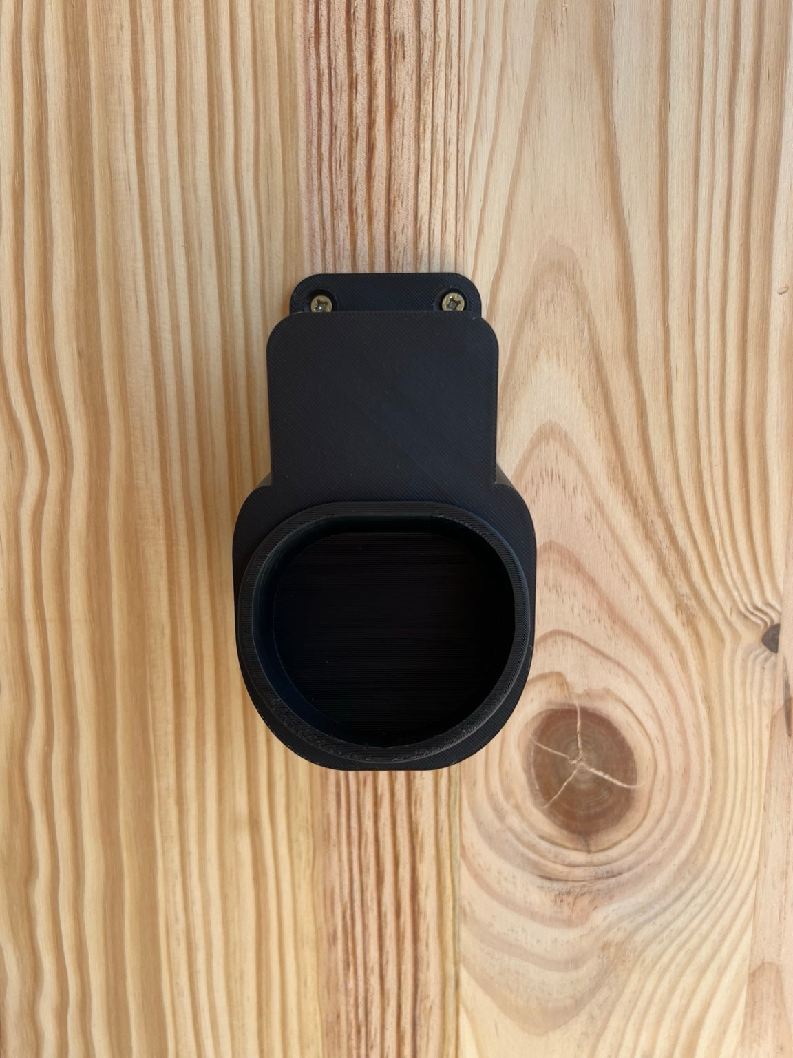 Front view of black 3D printed wall mounted holder for Type 2 EV plug